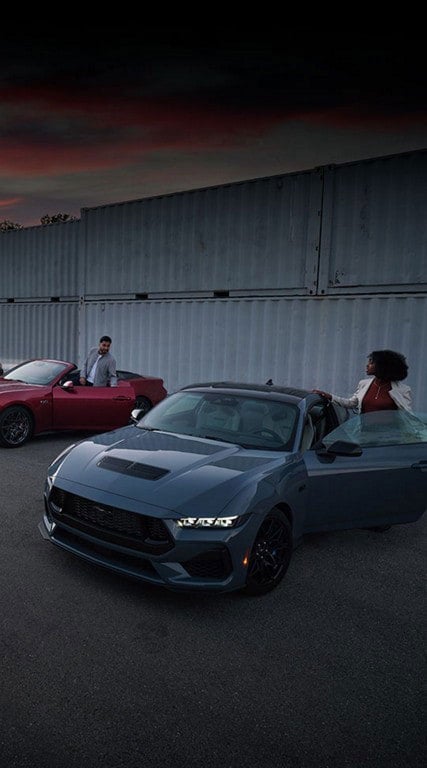 Two people exiting their parked 2024 Ford Mustang® coupe and convertible | Pierre Ford of Prosser in Prosser WA